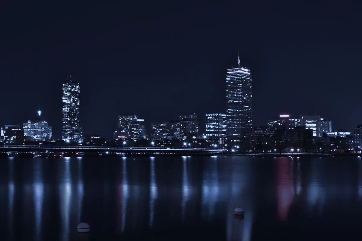 The Boston skyline at night across the Charles River.