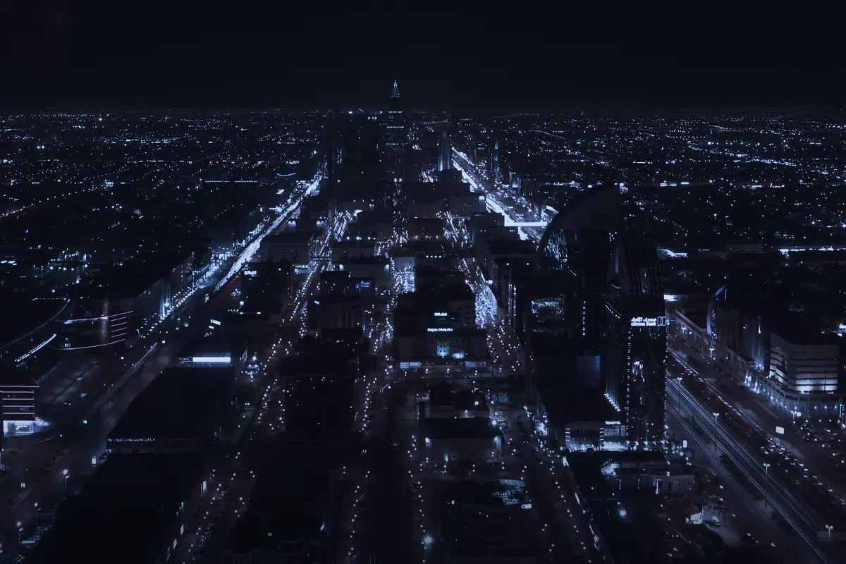 Riyadh at night from the air, arterial roads running out to the horizon.